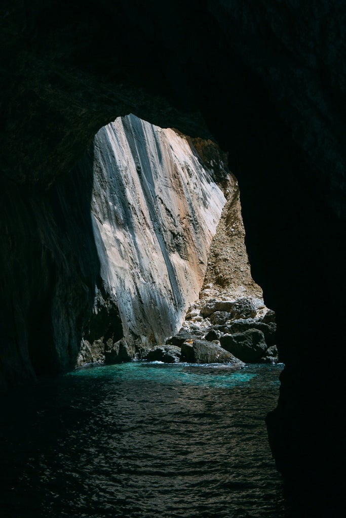 Luxury yacht sailing blue Ionian waters between lush Paxos and Antipaxos islands, crystal waters, verdant coastlines, and scenic Greek landscape