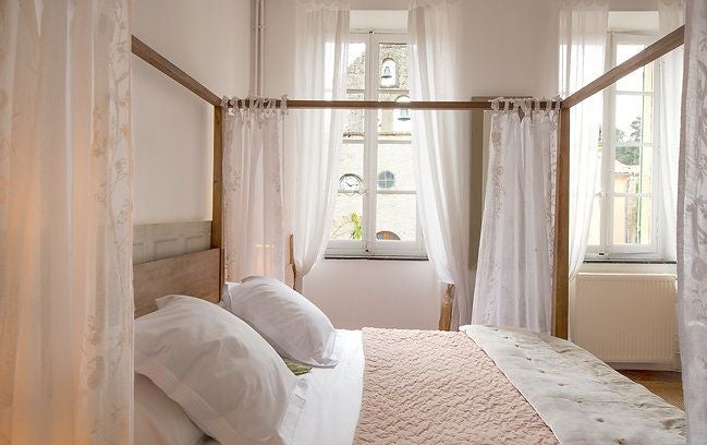 Elegant French hotel room with crisp white linens, minimalist design, soft natural light, and sophisticated neutral color palette showcasing refined comfort