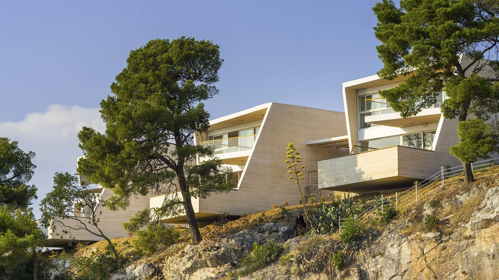 Luxurious Croatian seaside villa with contemporary design, panoramic Adriatic Sea view, minimalist interior, and sleek white furnishings at sunset