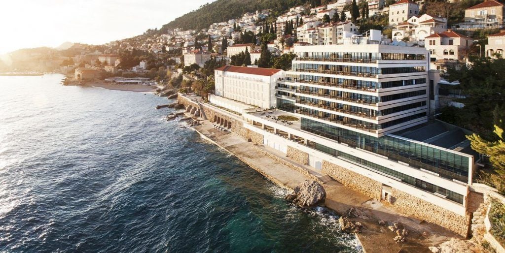 Elegant Hotel Excelsior perched on Adriatic cliffs in Croatia, featuring stone architecture, waterfront terraces and panoramic sea views