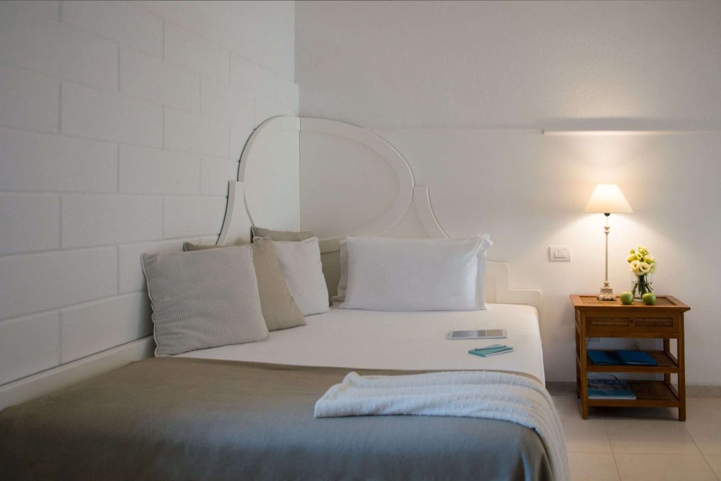 Luxurious pool view room at La Peschiera Hotel in Italy, featuring elegant decor, pristine white bedding, and a serene swimming pool glimpsed through large windows