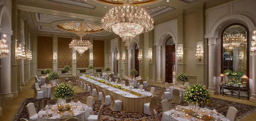 Opulent marble lobby of a luxurious palace-style hotel in New Delhi, featuring grand chandeliers, elegant decor, and traditional Indian architectural elements