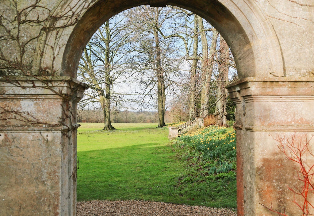 Elegant Edwardian country house hotel with manicured gardens, grand stone facade, and lush parkland in the scenic countryside of the United Kingdom.