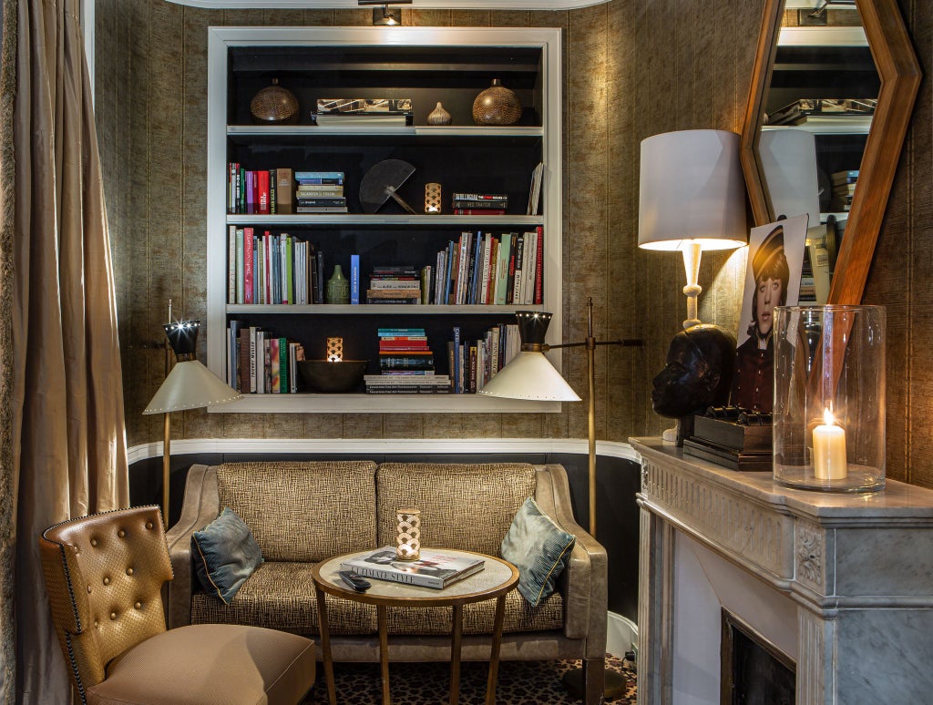 Elegant boutique hotel facade in Paris with soft-hued stone exterior, intricate wrought-iron balconies, and classic French architectural charm near Saint-Sulpice