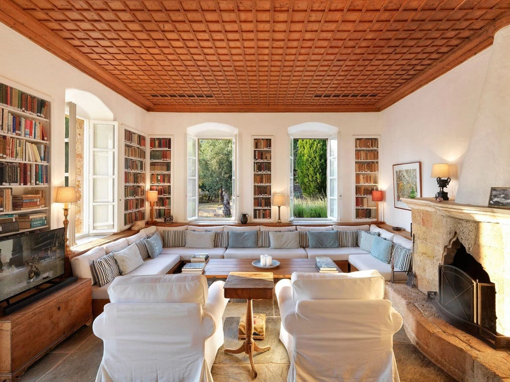 Elegant stone villa with terracotta roof overlooking azure Aegean Sea, featuring traditional Greek architectural design and panoramic Mediterranean landscape