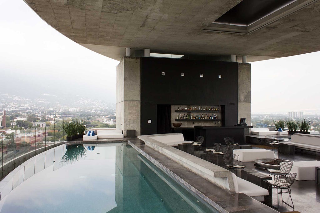 Modern minimalist luxury hotel with sleek white architecture, geometric design, and urban backdrop in Monterrey, showcasing contemporary Mexican architectural excellence