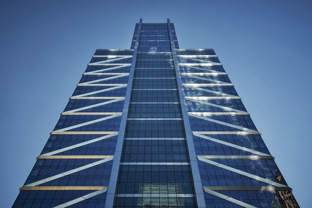 Luxurious Four Seasons Philadelphia hotel's glass tower reflects sunset, with city skyline and Comcast Center visible in background