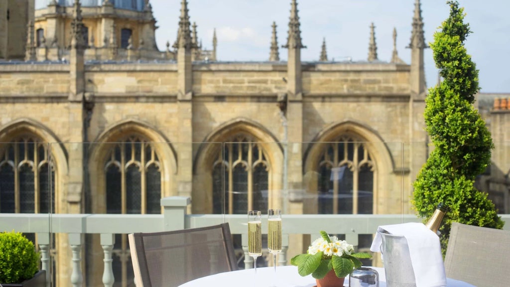 Elegant historic hotel exterior with grand stone facade, large windows, and refined architectural details showcasing British hospitality charm in a picturesque urban setting.