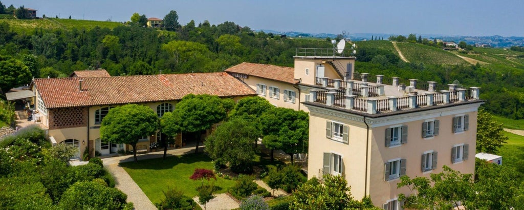 Elegant Italian coastal villa with terracotta rooftops, azure Mediterranean waters, lush gardens, and luxurious stone architecture overlooking scenic scenset landscape