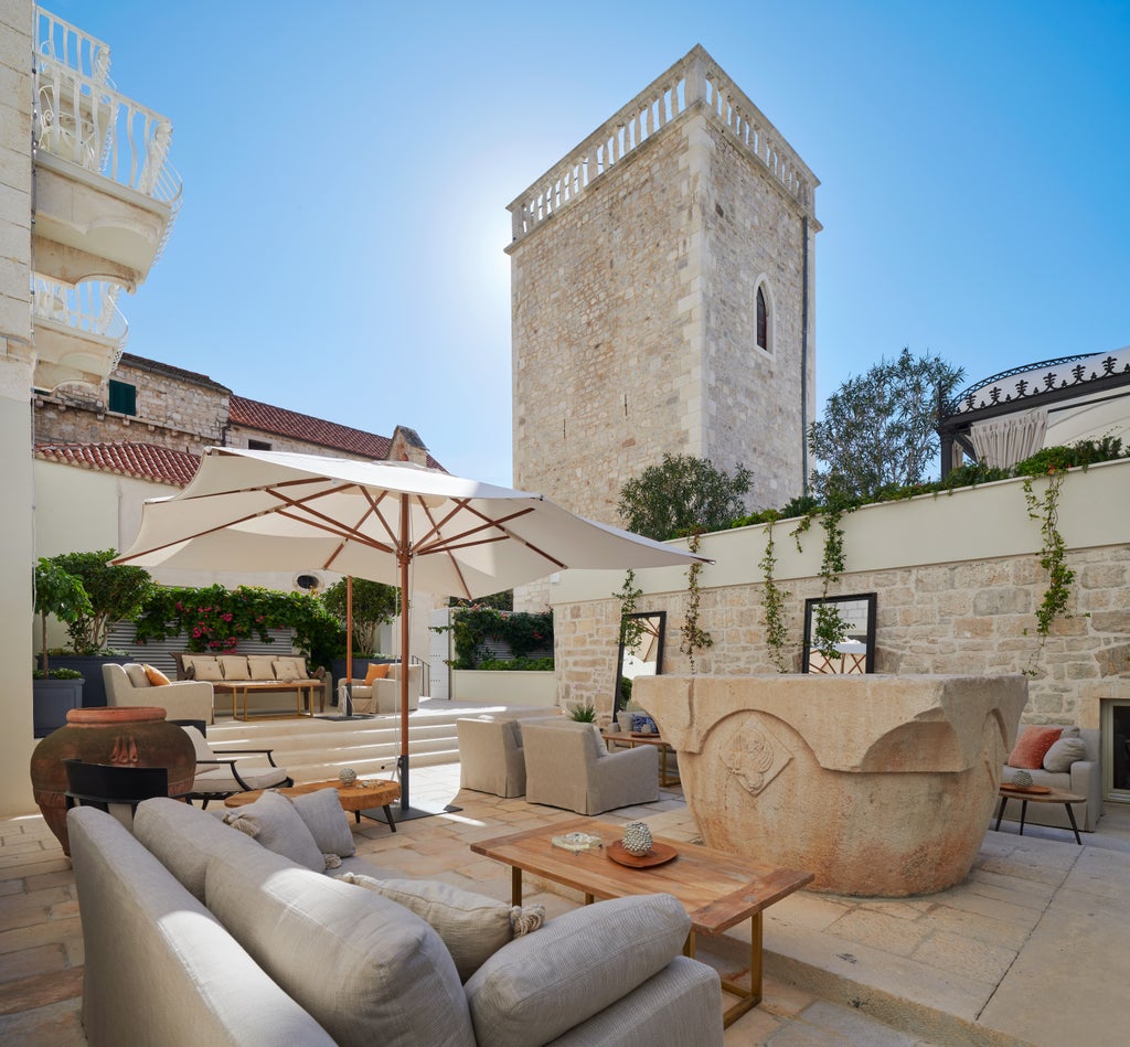 5-star heritage hotel Palace Elizabeth on Hvar Island with ornate white stone facade, arched windows and waterfront promenade views