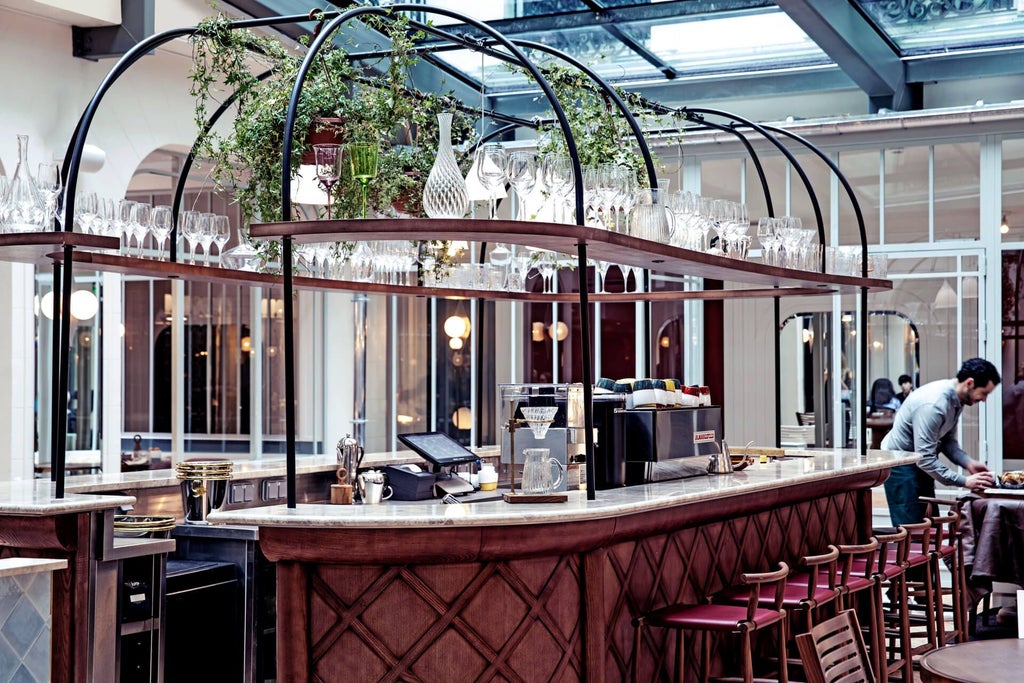 Elegant Parisian hotel lobby with ornate chandeliers, plush velvet seating, and classic French architectural details bathed in warm, golden light