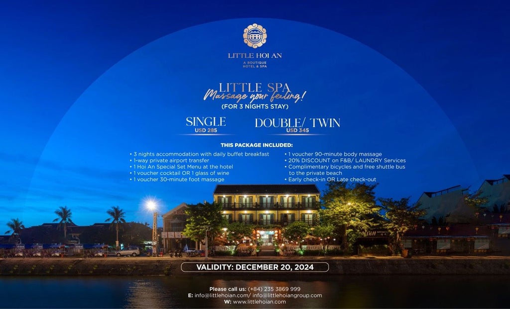 Luxurious boutique hotel facade in Hoi An, Vietnam, with traditional architecture, elegant white walls, tropical greenery, and inviting entrance at dusk