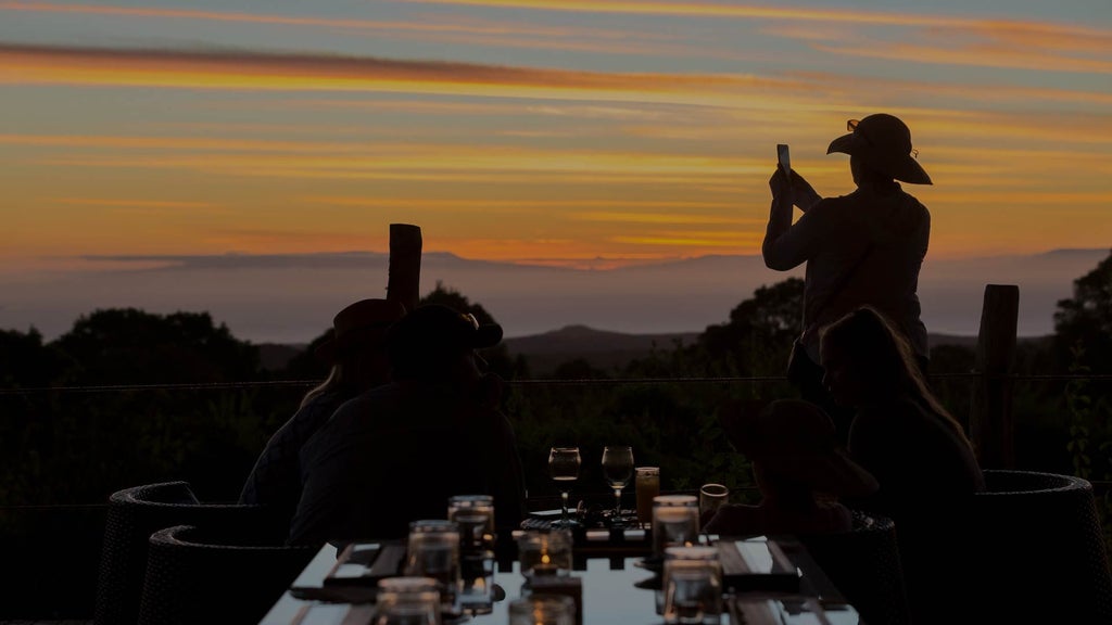 Luxurious safari tent with canvas walls, wooden floors, and private deck overlooking lush Ecuadorian Galapagos landscape at eco-friendly safari camp