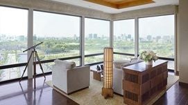 Luxurious exterior of The Peninsula Tokyo at twilight, featuring modern architectural design with glass facades and elegant lighting against urban Japanese skyline