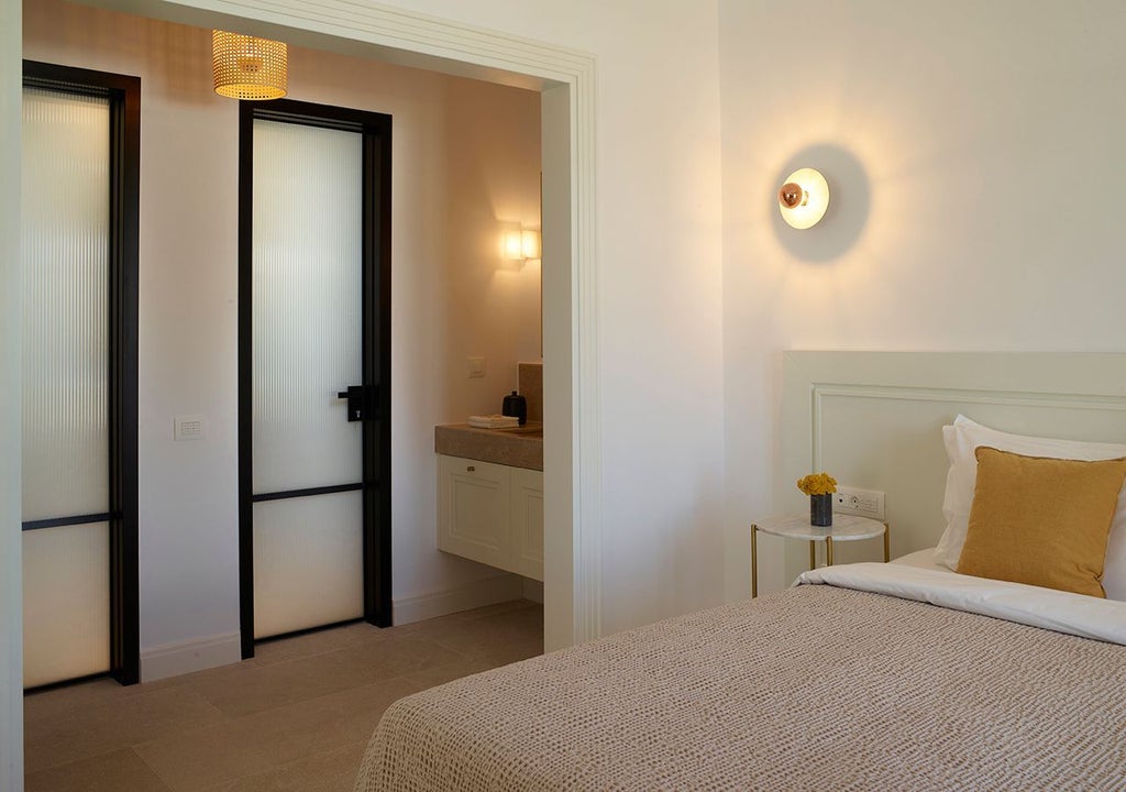 Luxurious one-bedroom suite at scenset Mykonos with expansive sea view, private heated pool, and elegant contemporary Mediterranean design.