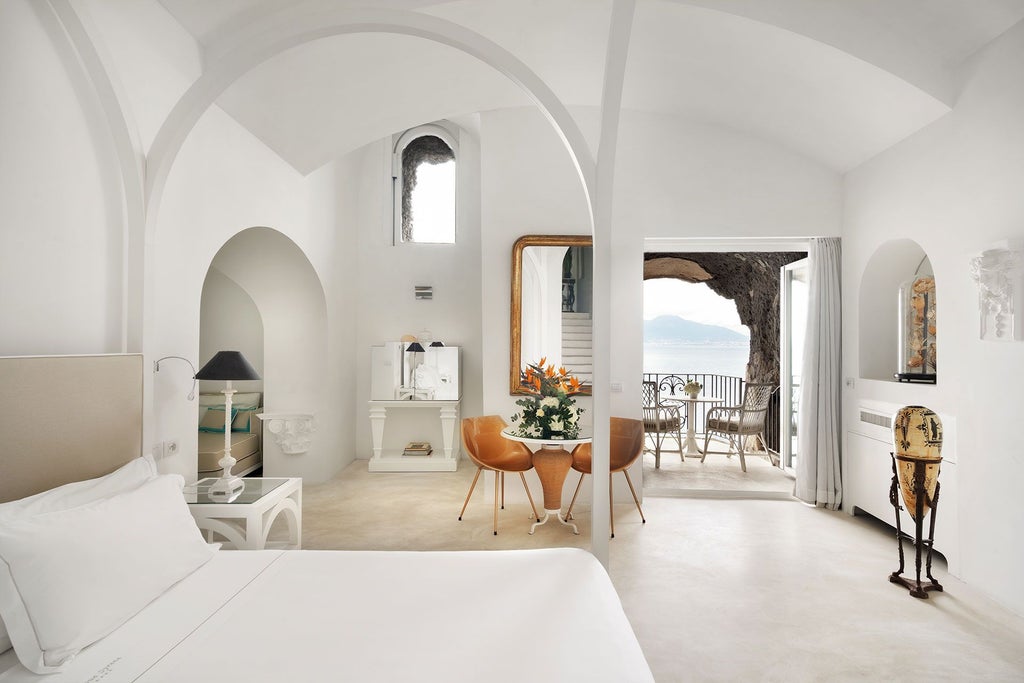 Opulent sea-view suite with elegant marble floors, classic antique furnishings, and sweeping panoramic views of coastal Sorrento landscape from picture windows