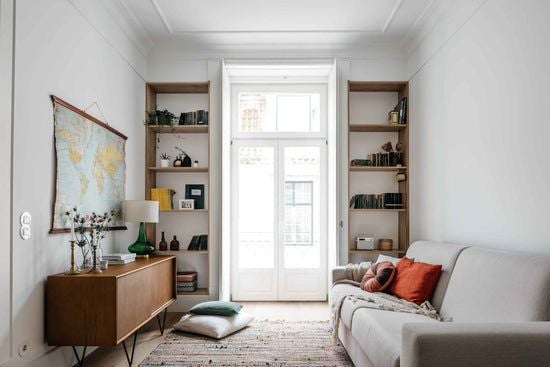 Modern, spacious one-bedroom apartment in Lisbon with minimalist design, large windows, elegant neutral color palette, and chic contemporary furnishings.