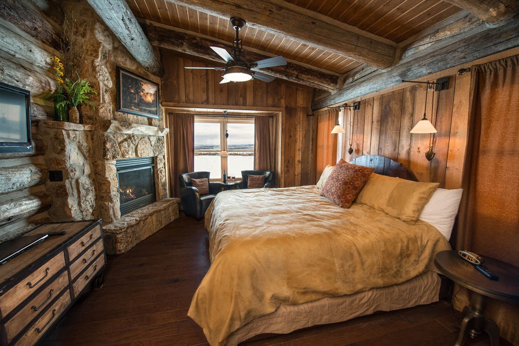 Rustic-luxe wooden lodge at Zion Mountain Ranch with panoramic mountain views, surrounded by pristine wilderness and golden meadows