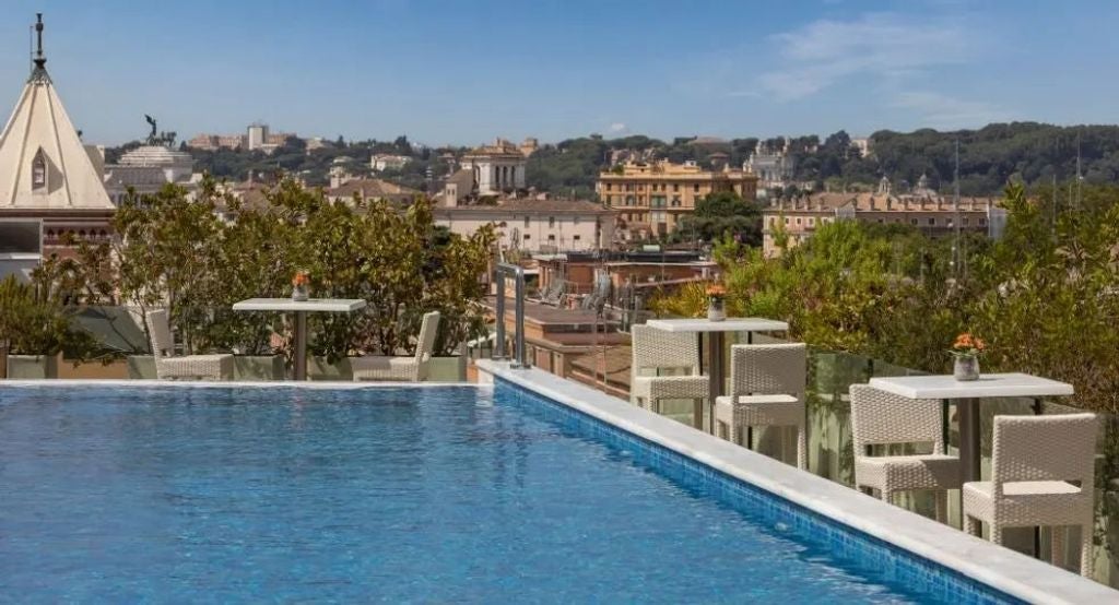 Five-star Anantara Palazzo hotel facade in Rome with neoclassical architecture, marble columns, and ornate balconies overlooking Piazza Repubblica