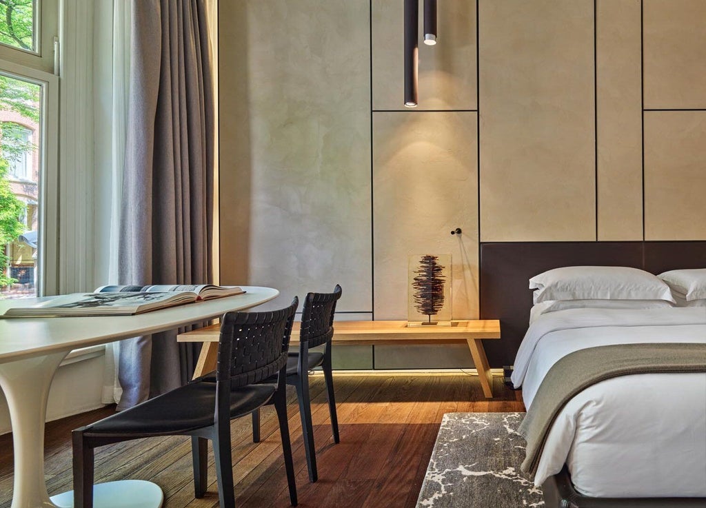 Luxurious garden-view suite at Scenset Conservatorium Hotel, featuring sleek modern design, plush bedding, and elegant furnishings with natural light streaming in