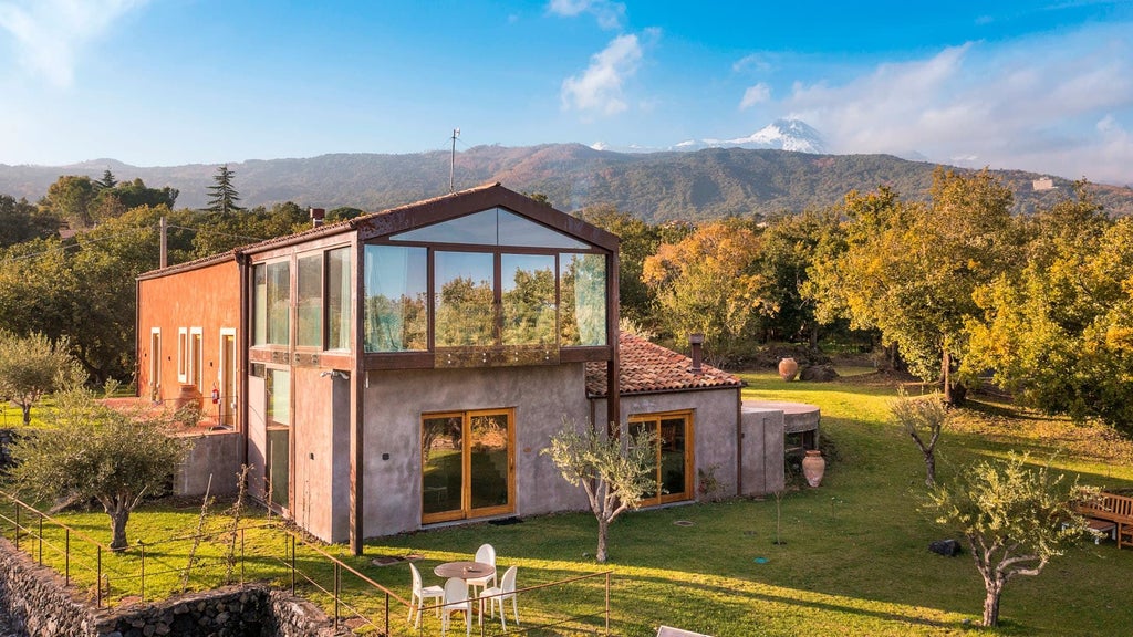 Luxurious Sicilian villa pool suite with elegant rustic decor, stone walls, and panoramic countryside views at Monaci delle Terre Nere estate