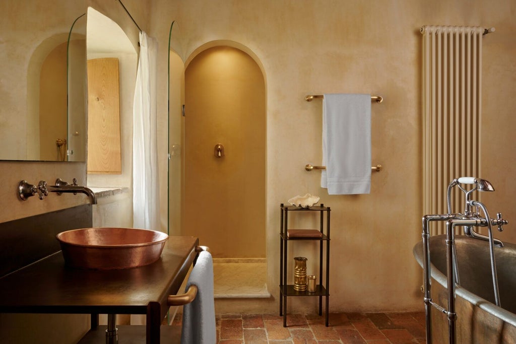 Rustic-chic Tuscan suite with stone walls, elegant four-poster bed, and panoramic countryside views at luxury boutique hotel in rural Italy