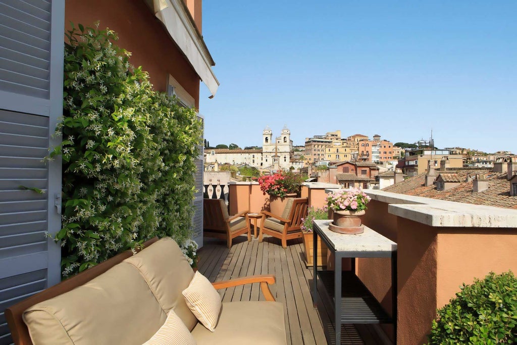 Elegant rooftop terrace overlooking Rome's historic skyline, with luxurious white furnishings and panoramic views of ancient architecture at a boutique hotel