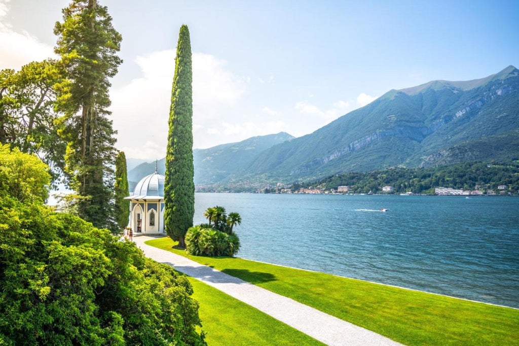 Opulent Italian villa hotel with neoclassical facade overlooking Lake Como, featuring manicured gardens and mountain backdrop