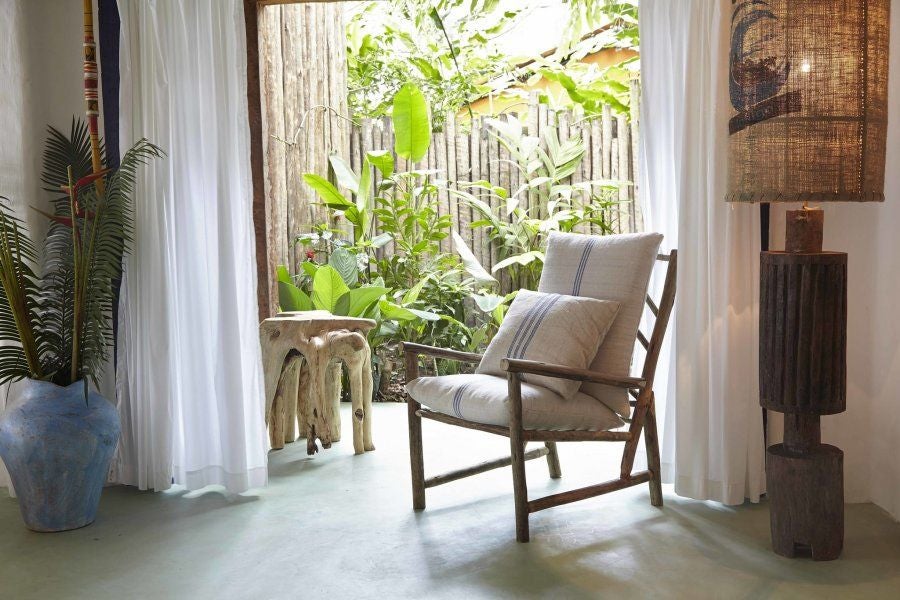 Luxurious rooftop terrace suite at UXUA Casa Hotel with rustic wooden deck, plush lounge chairs, and panoramic tropical landscape view in Brazil