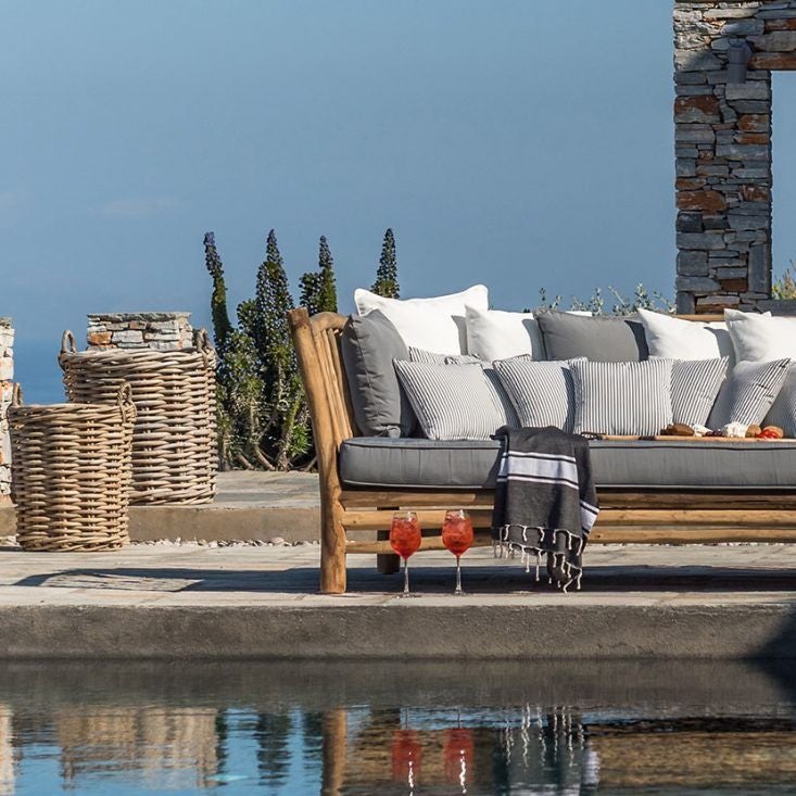 Luxurious white Cycladic hotel with minimalist architecture overlooking azure Aegean Sea, featuring pristine infinity pool and stunning sunset horizon in Sifnos, Greece