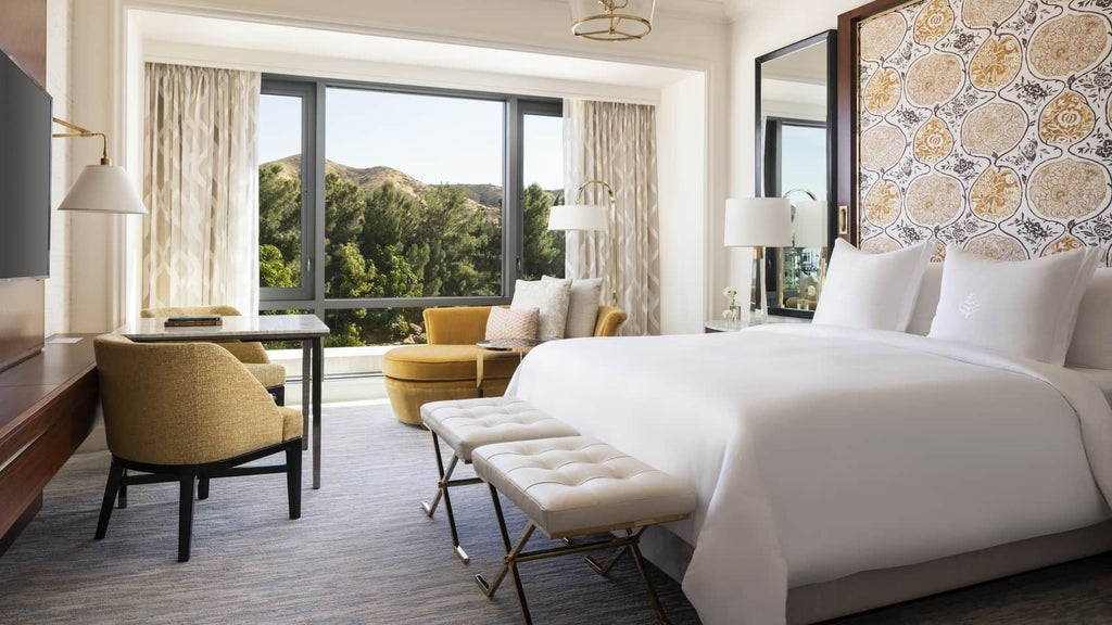 Luxurious waterfall-view room at Four Seasons Hotel in Westlake Village, featuring modern decor, plush bedding, and expansive windows with serene cascading water backdrop