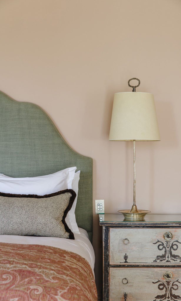 Elegant hotel room featuring soft English rose tones, luxurious cedar wood accents, plush white bedding, and sophisticated neutral decor in a refined United Kingdom setting