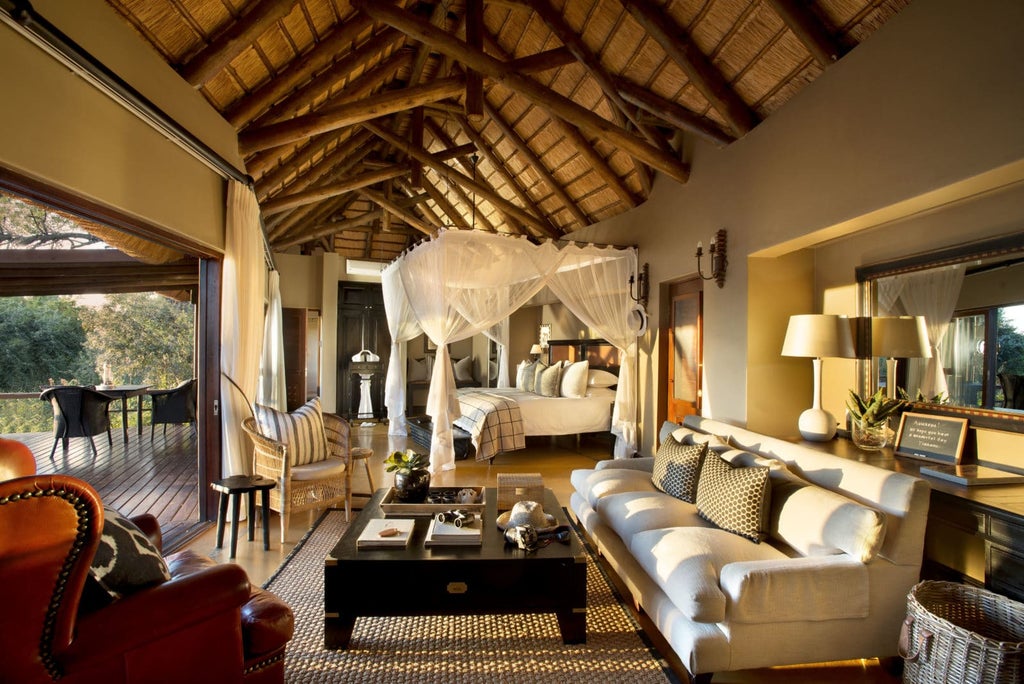 Luxurious safari lodge overlooking Sabie River with private viewing deck, infinity pool, and thatched roof against savanna backdrop