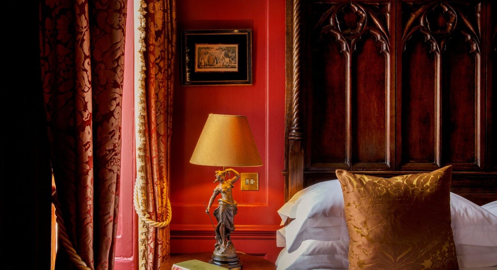 Elegant club double room at Hazlitt's, featuring plush bedding, rich wooden furnishings, and classic British design with sophisticated vintage charm