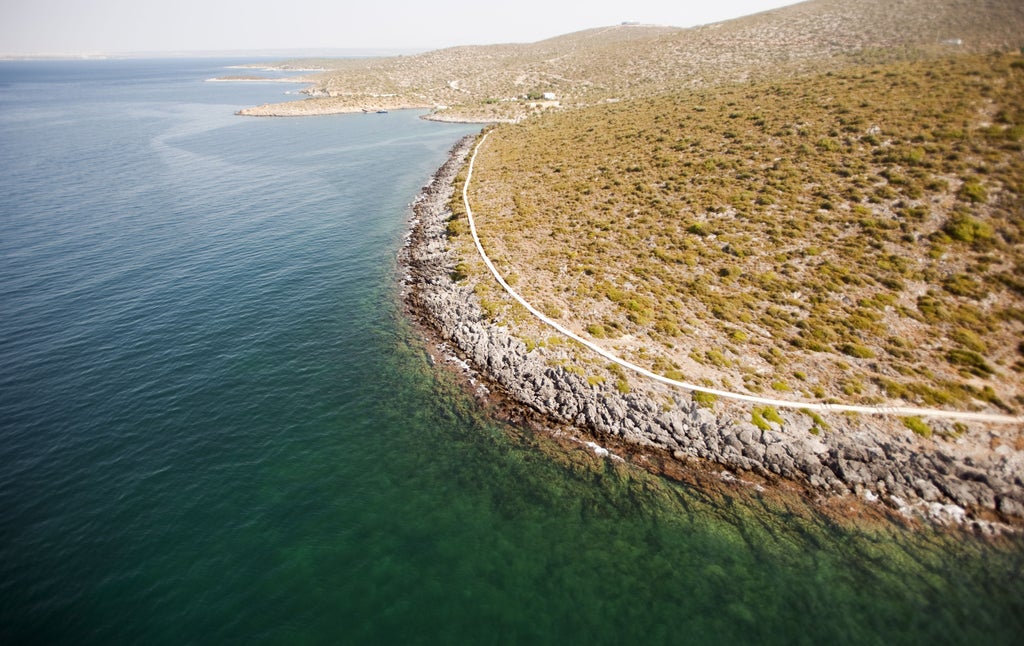 Serene coastal view of Six Senses Kaplankaya resort in Turkey, featuring modern architecture nestled into rugged cliffs above turquoise waters