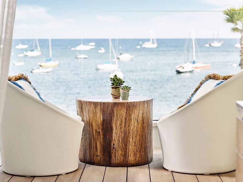 Elegant white-draped Deluxe Room at Nobu Hotel in Ibiza Bay, featuring plush bedding, contemporary coastal design, and expansive ocean view windows