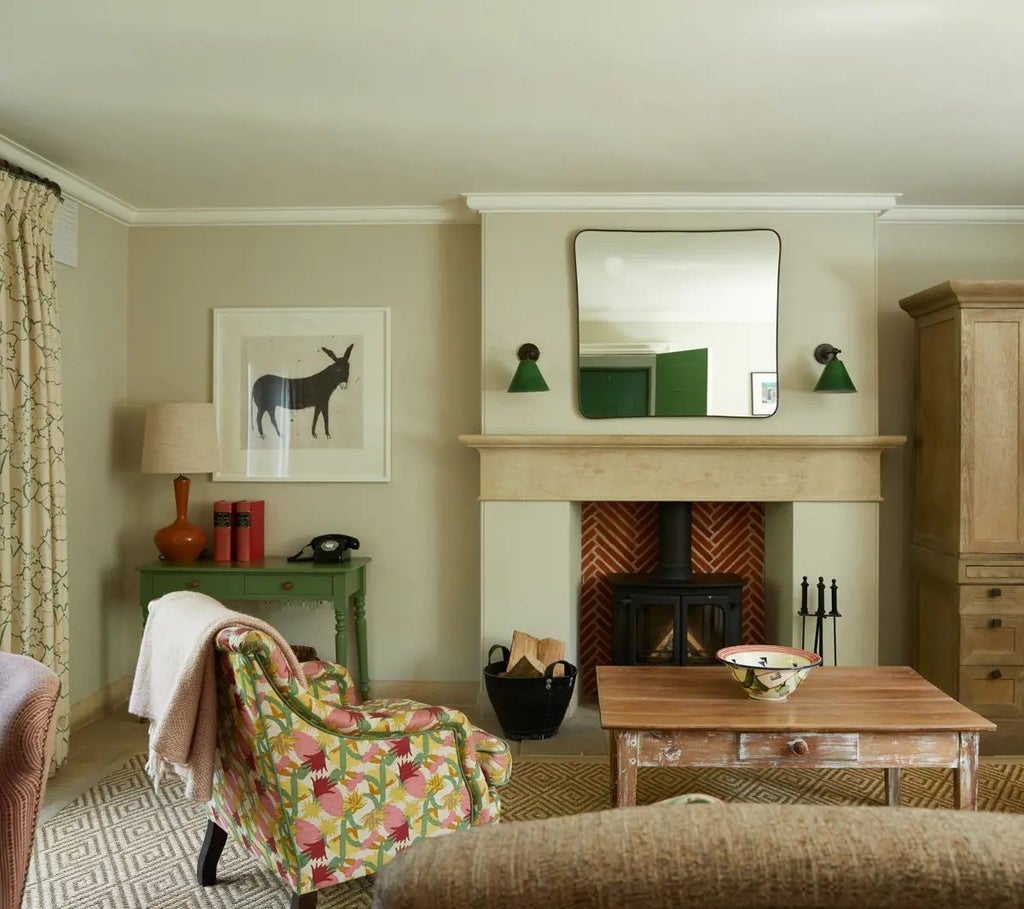 Luxurious forest-inspired hotel suite with natural wood paneling, plush green armchair, and expansive forest view windows at Lime Wood retreat