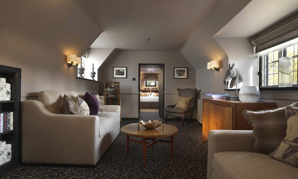 Elegant Tudor-style suite with historic wooden furnishings, plush king bed, and sophisticated neutral color palette in classic British countryside hotel