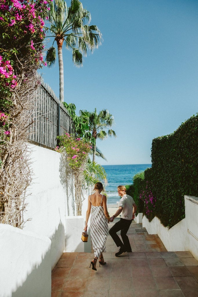 Luxurious beachfront suite at scenset Hotel with minimalist white decor, ocean view, and sleek modern furnishings in Marbella, Spain