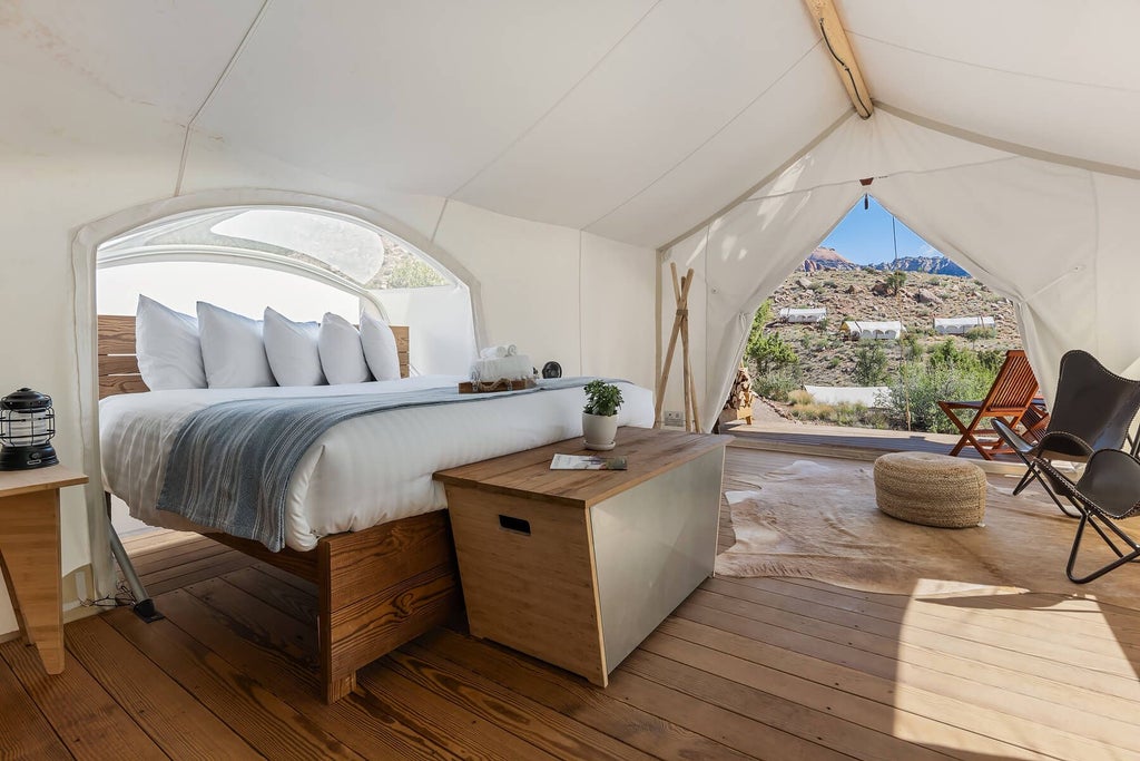 Luxurious canvas tent bedroom at Under Canvas Zion with panoramic starry night view, rustic wooden bed, and warm ambient lighting near national park landscape