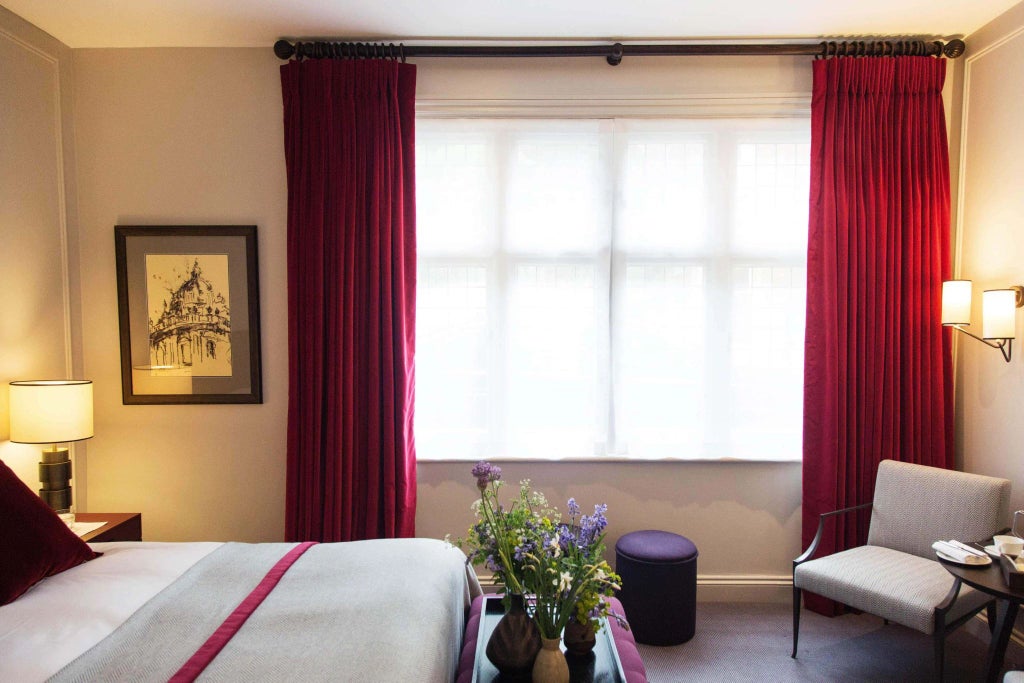 Elegant accessible hotel room with soft neutral tones, plush bedding, contemporary furnishings, and thoughtful design at historic Old Parsonage Hotel in United Kingdom