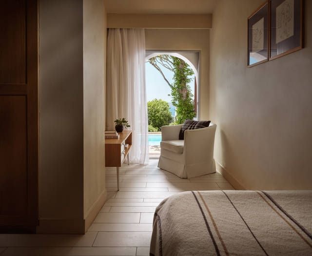 Luxurious two-bedroom bungalow at Eagles Palace resort, overlooking azure Aegean Sea with private infinity pool and elegant Mediterranean design