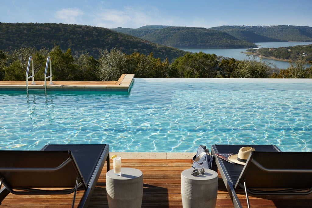 Modern wellness resort nestled in Texas hillside features infinity pool overlooking lush forest canopy with luxurious lounge chairs