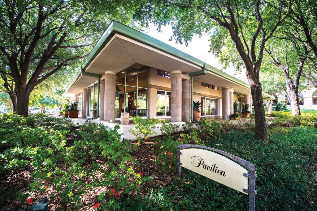 Elegant Five-star Four Seasons Hotel Dallas with Mediterranean-style architecture, grand entrance fountain, and manicured gardens at sunset