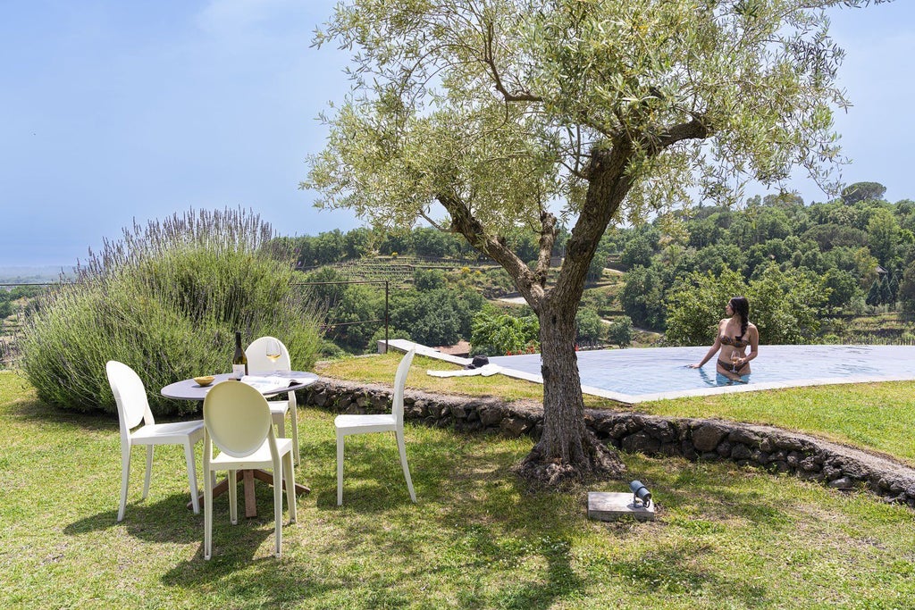 Elegant two-bedroom pool villa at Monaci delle Terre Nere, featuring rustic chic decor, sweeping Sicilian landscape views, and private infinity pool at sunset