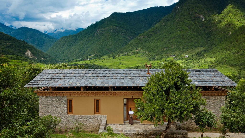 Spacious luxury COMO Villa bedroom in Punakha, Bhutan, with traditional wooden floors, panoramic mountain views, and elegant minimalist design