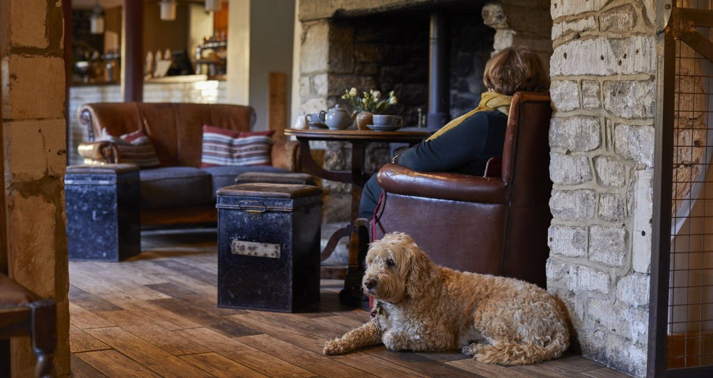 Historic riverside restaurant with elegant stone facade, soft lighting, and traditional British architectural charm in Bradford on Avon, Wiltshire.