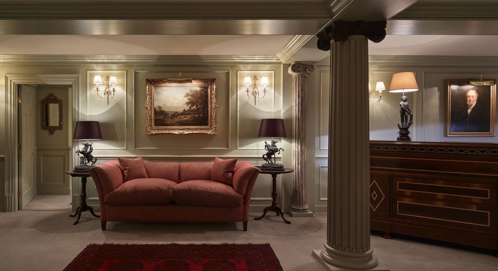 Opulent boutique hotel bedroom with Georgian-inspired decor, plush velvet furnishings, ornate wallpaper, and elegant four-poster bed in a historic United Kingdom setting