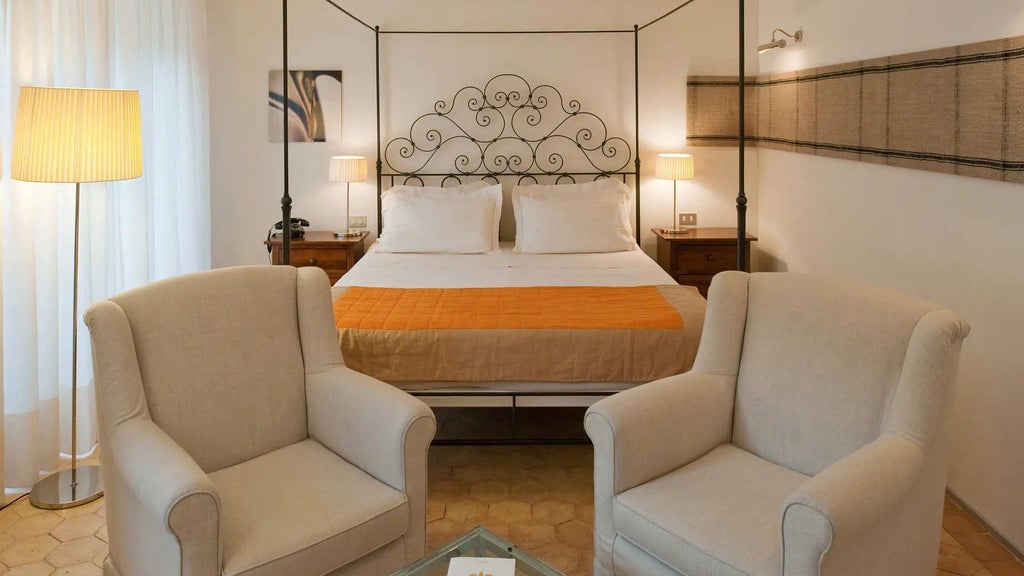 Elegant Deluxe Room at Palazzo Seneca, featuring luxurious traditional Italian decor with rich wooden furnishings and soft neutral color palette