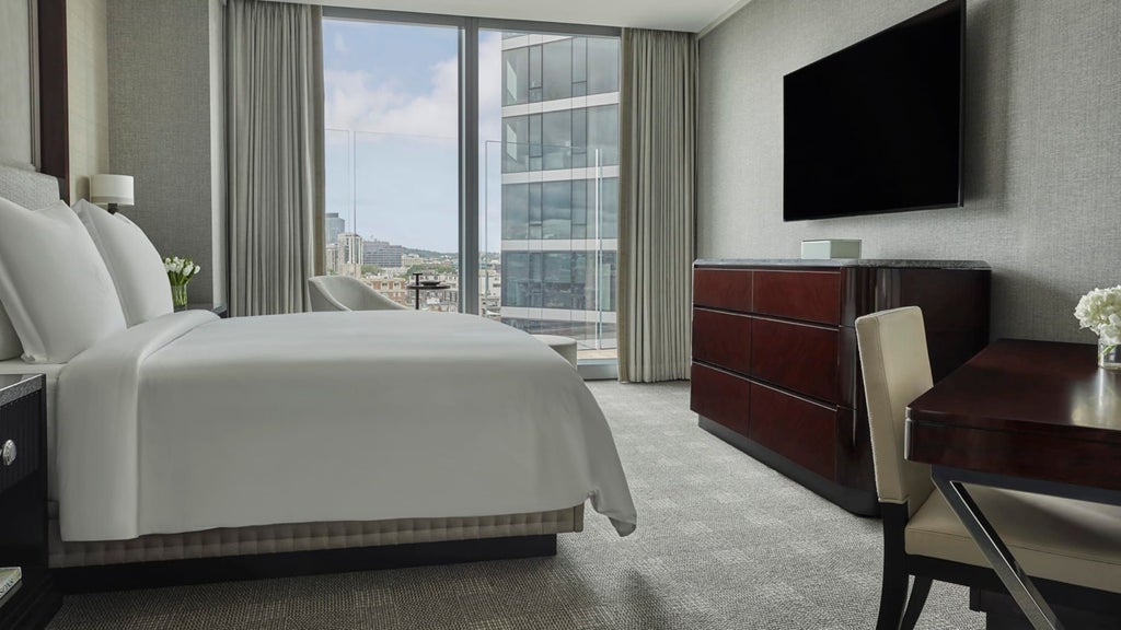 Luxurious Charles Suite at scenset Hotel, featuring elegant contemporary design with panoramic city views and sophisticated neutral color palette